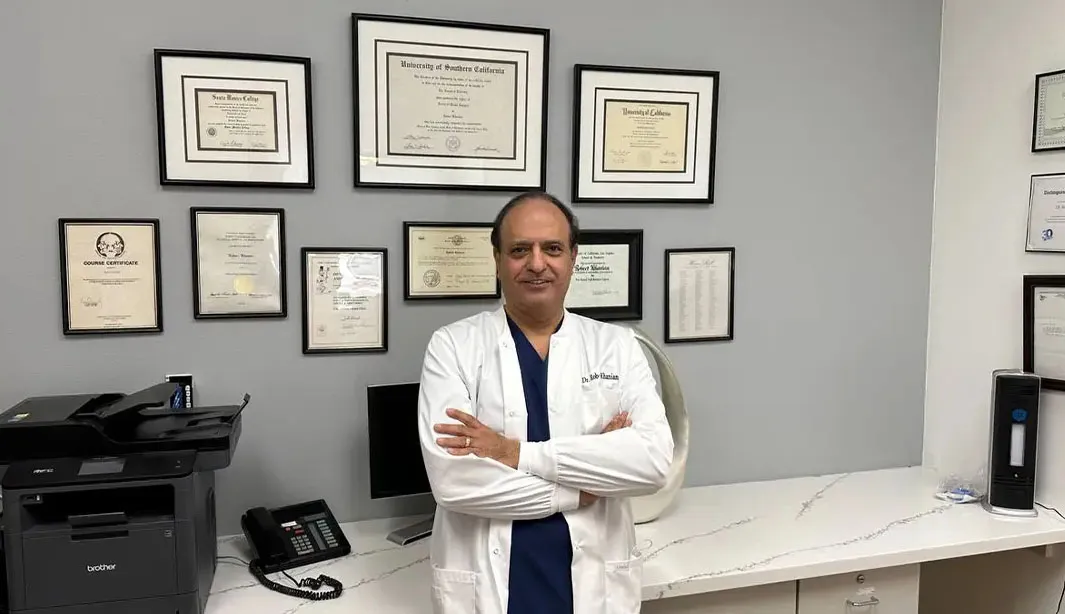 Dr. Robert Khanian in the office with his awards