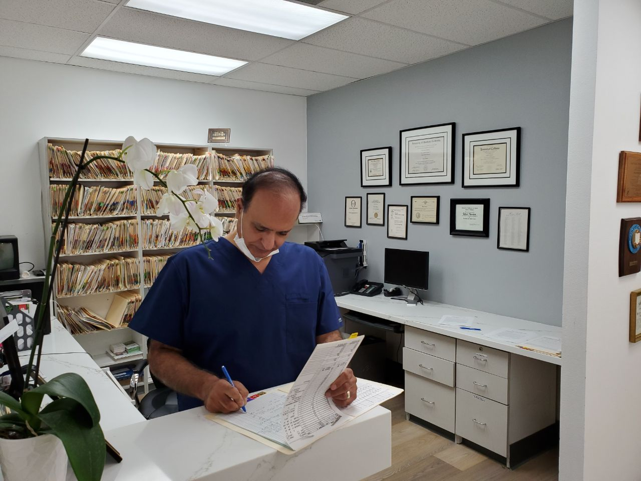 An image of a doctor working in his office