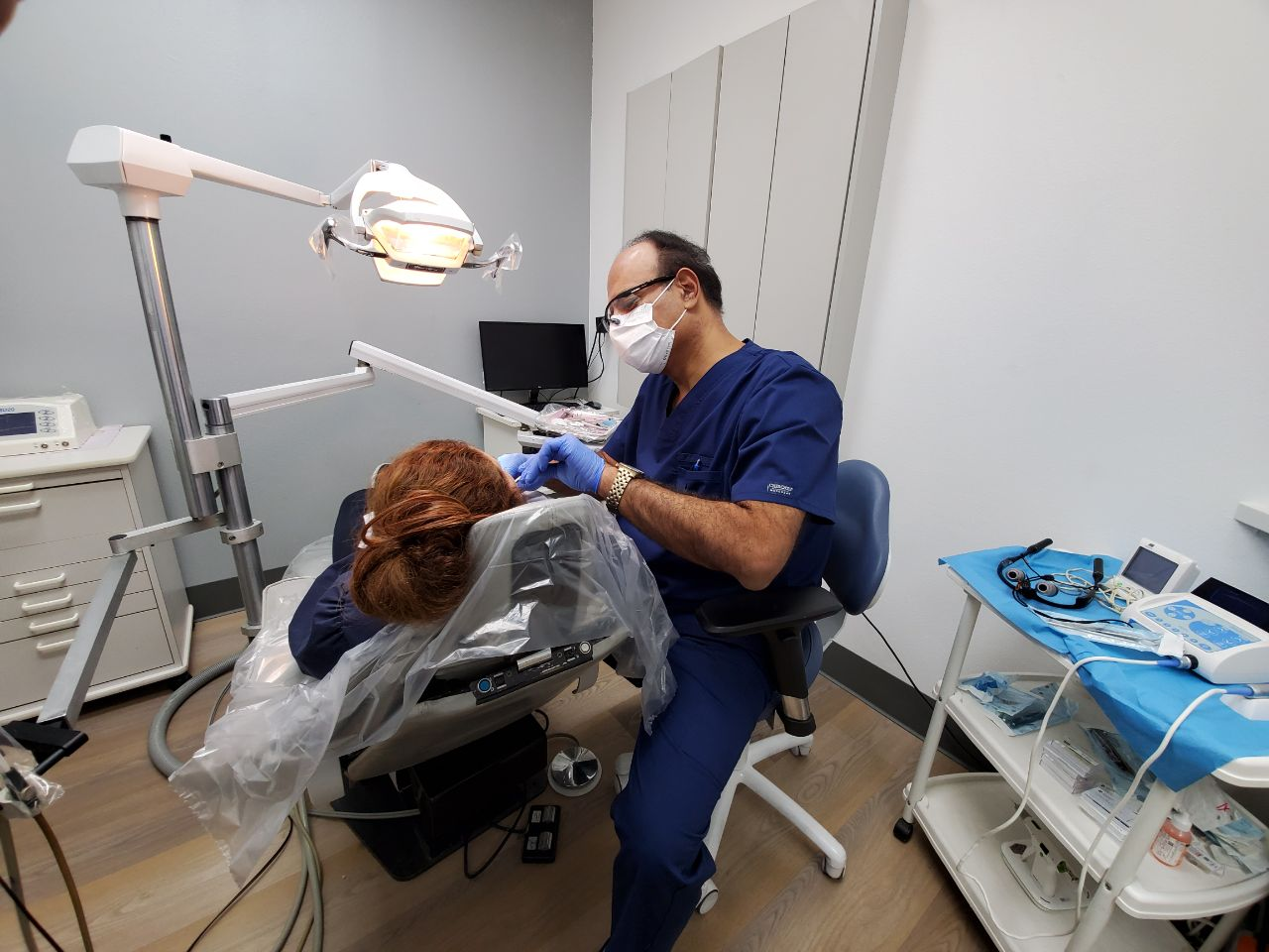 An image of Dr. Robert Khanian with a patient in his dental clinic in Tarzana, California 