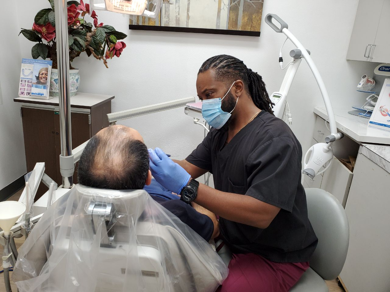 An image of a dentist doing a procedure on a patient in a dental clinic in Tarzana, California 