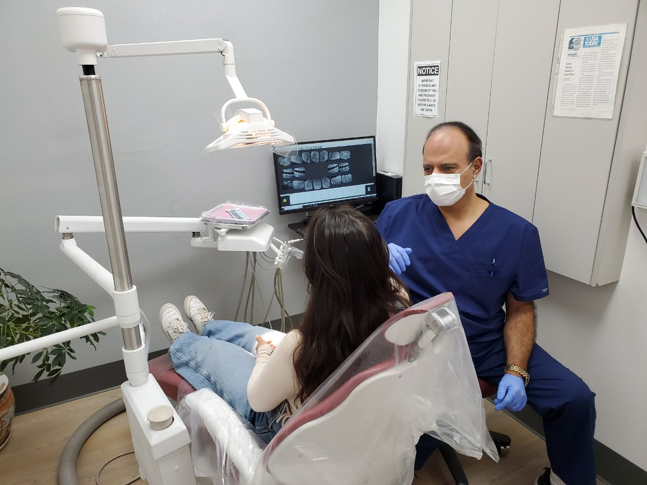 An image of Dr. Robert Khanian with a patient in his dental clinic in Tarzana, California 