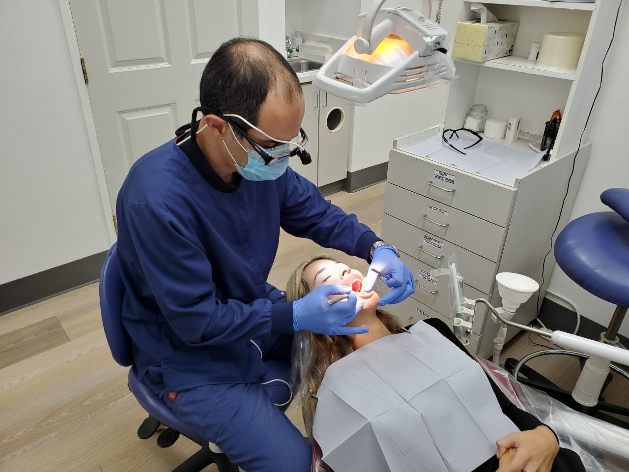 A woman getting a dental checkup from All Smiles Family Dentistry for dental veneers