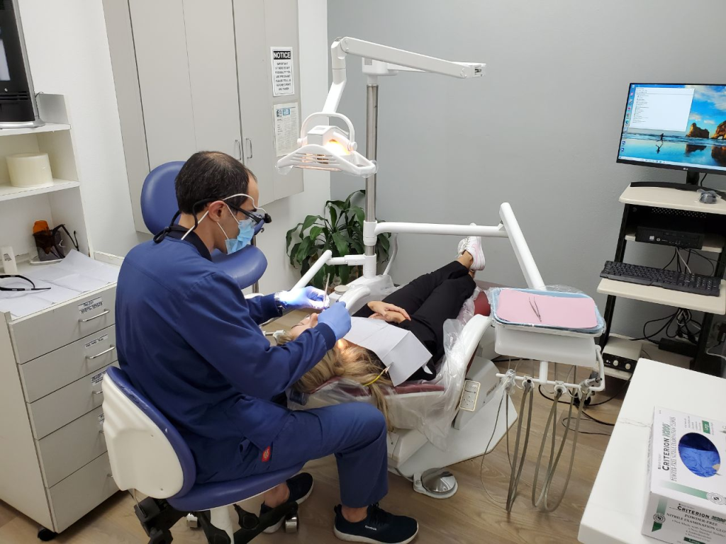 A woman getting dental care from aAll Smiles Family Dentistry dentist in Tarzana