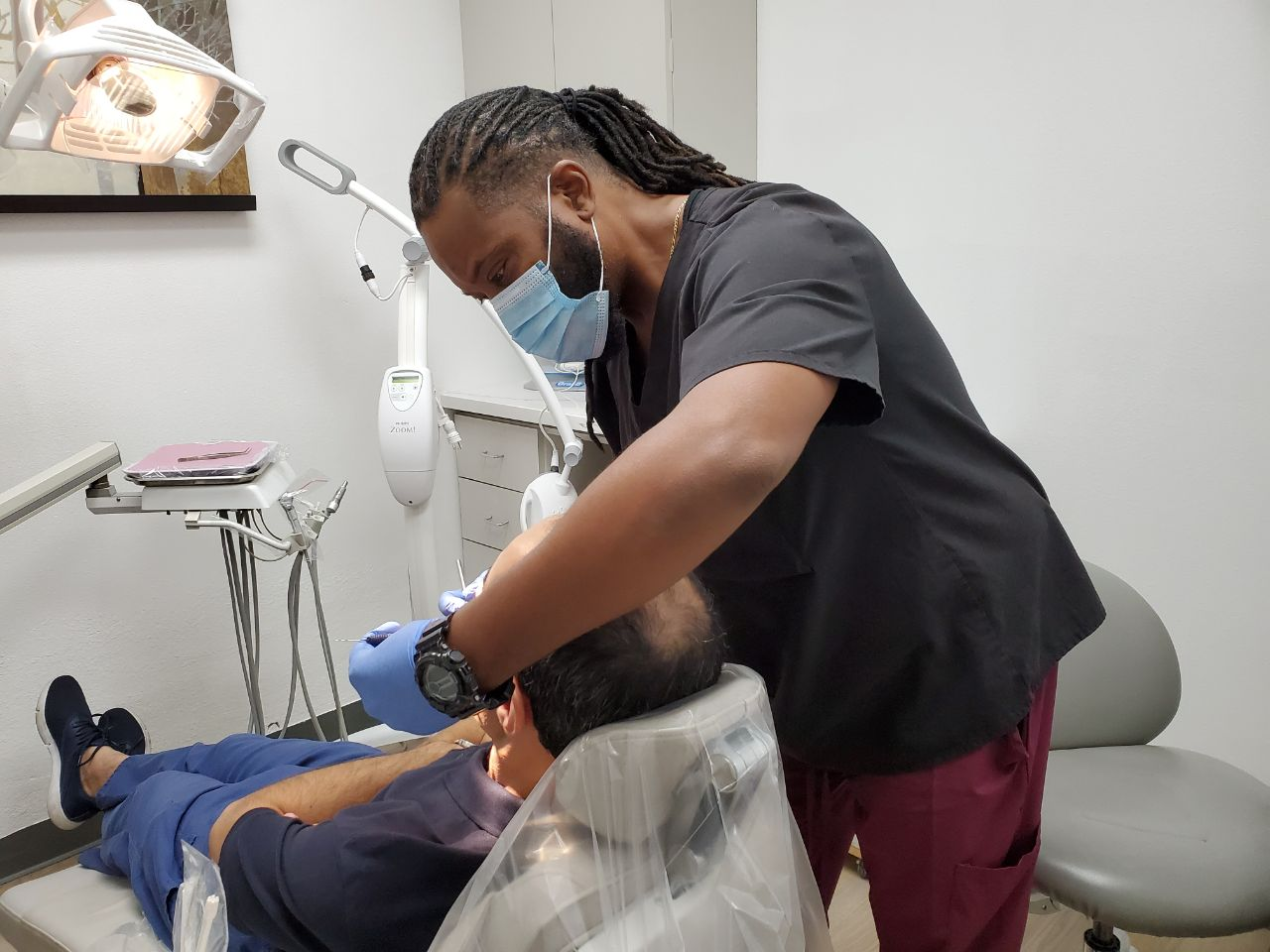 A dentist is examining a patient's teeth
