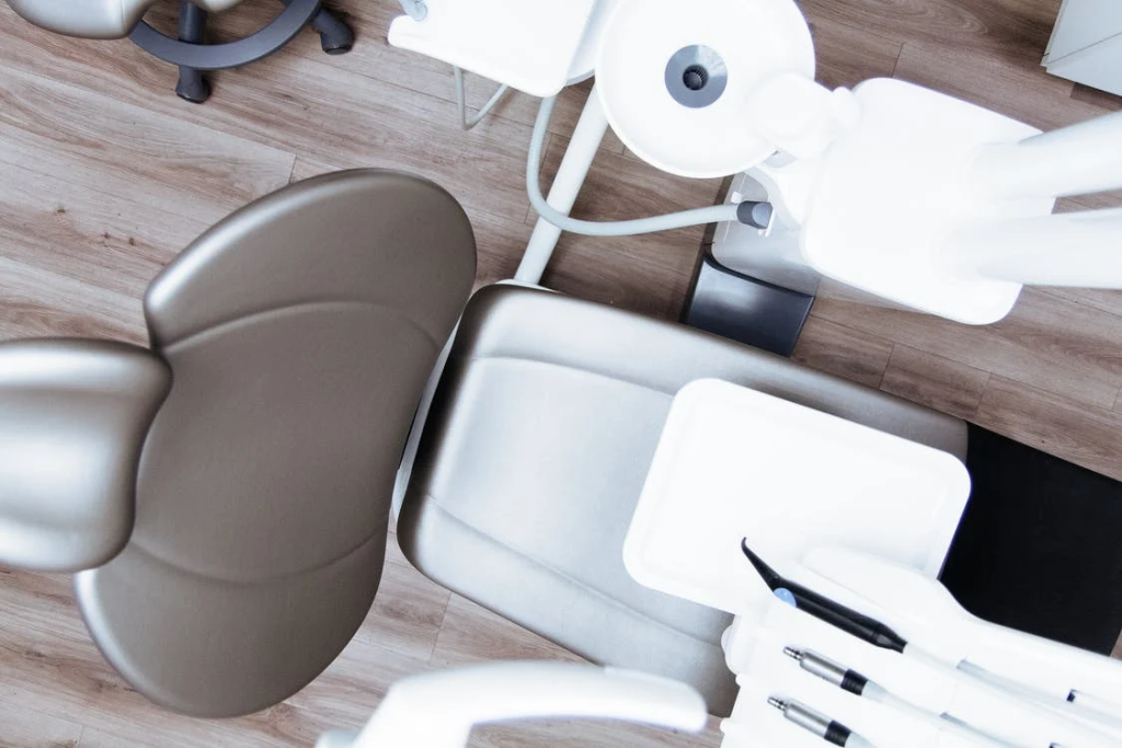 An image of a dental chair and equipment in a clinic