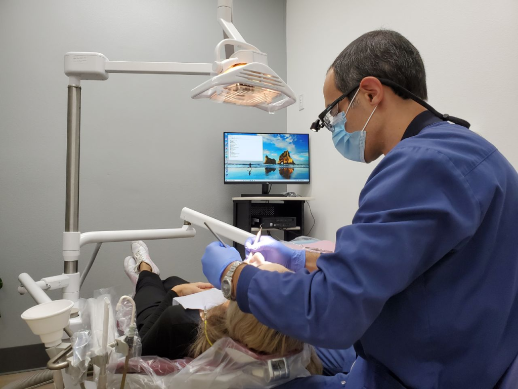 An image of Dr. Robert Khanian with a patient in his dental office in Tarzana, California