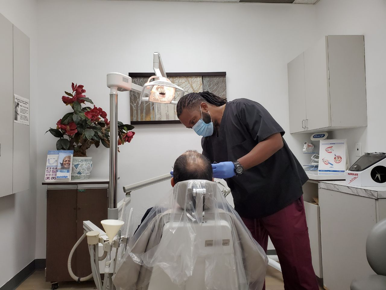 An image of a dentist doing a procedure on a patient in a dental office in Tarzana, California