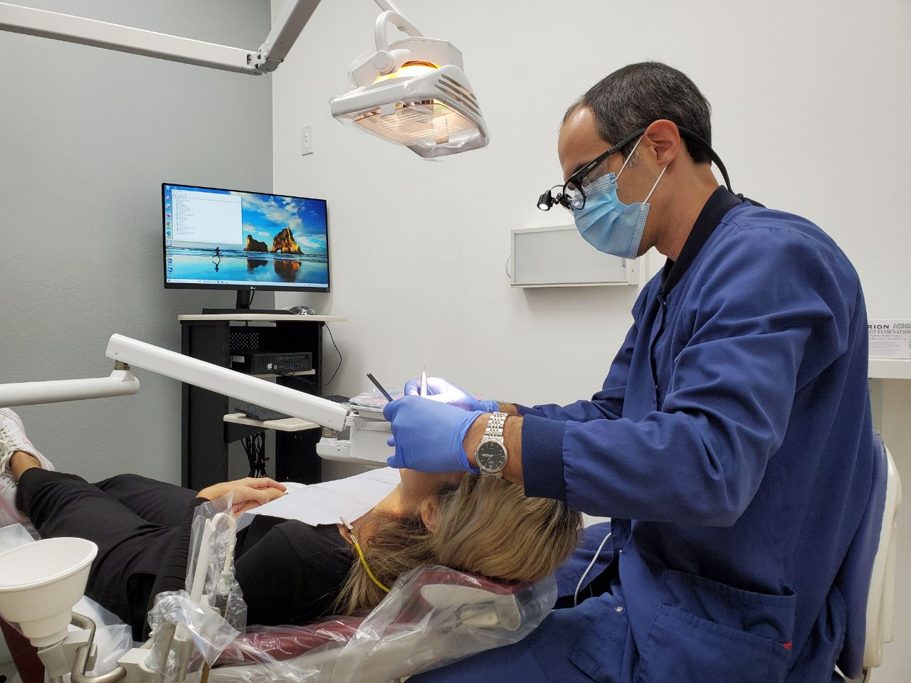 A dentist from All Smiles Family Dentistry Examining a female patient in Tarzana dental office