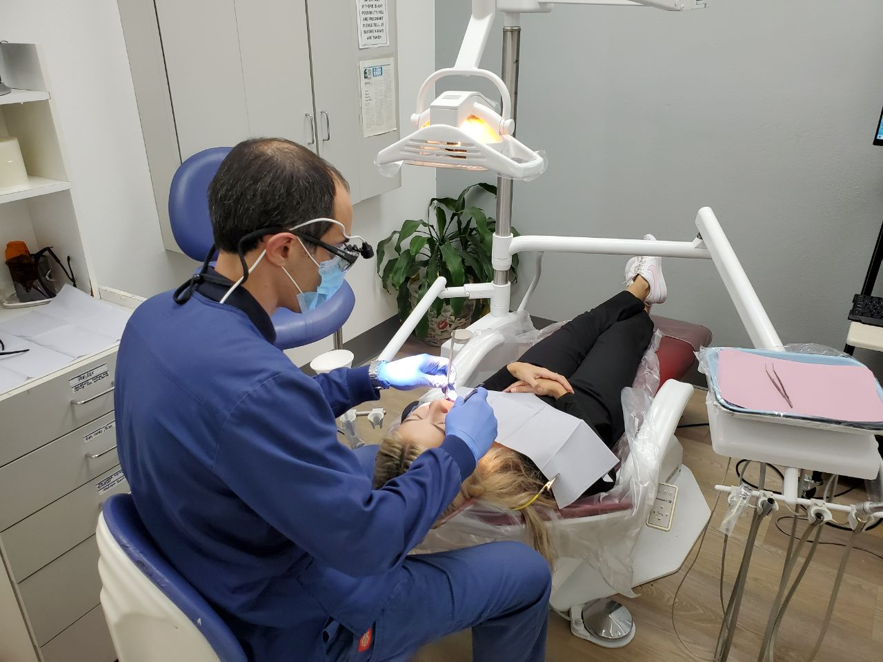 dental hygienist checking a patient with a dental emergency